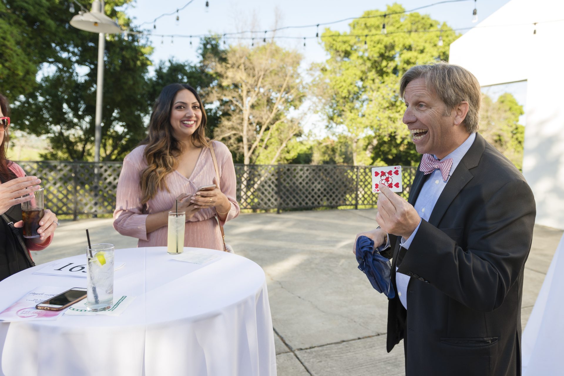 Tom Collett performing close-up magic outdoors at golden hour