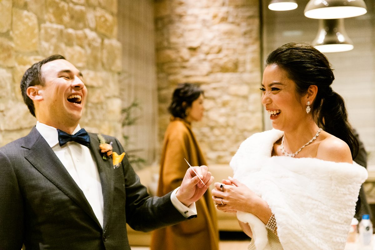 Wedding guests laughing during close-up magic
